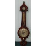 A Victorian wheel barometer by Puibus, in a figured mahogany case, 104cm long. (AF)