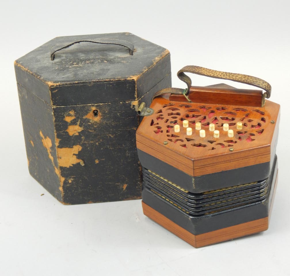 A late 19thC Lachenal and Co London concertina, in a mahogany case, with ivory buttons.