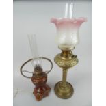 Oil lamps, to include a brass column example with pink tinted etched shade.