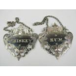 A pair of 19thC silver plated decanter labels, of pierced and engraved shield shaped design, for rum