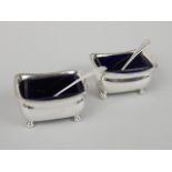 A pair of George III silver rectangular salts, each with bun feet, and a blue glass liner, London