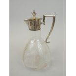 A early 20thC cut glass claret jug, with plated chased mounts raised with thistles with an angular