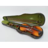 A violin with two piece back and two violin bows, in a fitted case, length of back 36cm.