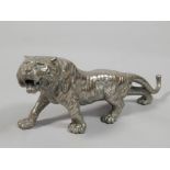 A Japanese type silvered copper figure of a tiger, in Meiji style, 34cm long.
