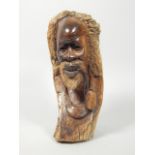 Tribal Art. African carving in the form of an old man smoking a pipe, 37cm high.