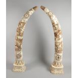 An unusual pair of early 20thC Japanese bone tusks, with shibayama carving of figures etc., part