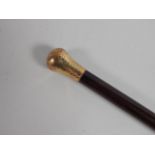 A Continental mahogany walking stick, with a hammered gold plated handle, 85cm long.