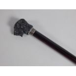 A 20thC ebonised walking stick, the composition handle cast in the form of a tiger's head, 89cm