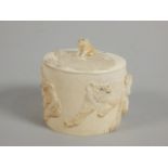 A 19thC Japanese carved ivory box, decorated in relief with tigers etc., the lid with an applied