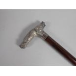 A Continental mahogany walking stick, the handle cast with a head of a wild boar and a hound in