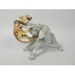 A Continental porcelain figure group in the form of a tiger attacking an elephant, unmarked, 28cm