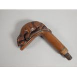 A 19thC hardwood walking stick handle, carved in the form of a mongoose and a snake, 59cm long.