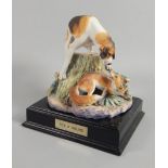 An Albany fine porcelain figure, of a fox and hound, modelled by Neil Campbell, on an ebonised base,