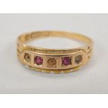 A Victorian 15ct gold dress ring, set with rubies and diamonds, 1.8g all in.