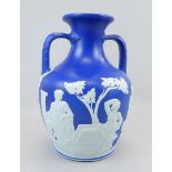 A 19thC Wedgwood blue Jasperware copy of the Portland vase, with two handles, impressed mark to