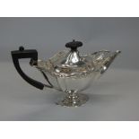 An Edwardian silver teapot, with a pierced border, ebonised knop and handle, on a domed foot,