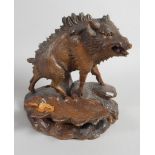 An early 20thC Black Forest carving in the form of a wild boar, the rectangular base applied with