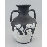 A Wedgwood black Jasperware version of the Portland vase, with two handles, impressed mark to