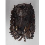 A late 19thC/early 20thC Black Forest linden wood carving, in the form of a wild boar with real