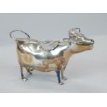 A silver cow creamer, modelled in the form of a cow, the lid engraved with flowers, and applied with