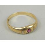 An 18ct gold ruby and diamond dress ring, with three illusion set stone.