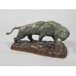 After Rousseau. Green paternated figure of a tiger on a brown paternated bronze base, impressed