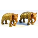 A near matching pair of early 20thC Czechoslovakian figures of elephants, in green and brown with