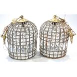 A pair of highly decorative light shade lanterns, each of pierced outline with crushed metal