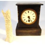 A 19thC black slate mantel clock, the 10cm dial key wind movement with key, 24cm high, and a heavily