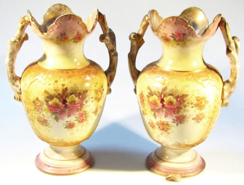 A pair of Edwardian Valkyrie Humphries Tunstall vases, each with castellated tops and shouldered