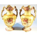 A pair of Edwardian Valkyrie Humphries Tunstall vases, each with castellated tops and shouldered