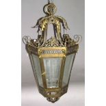 A Victorian gilt brass hanging lantern, with scroll framework, satyr masks and bevelled glass,