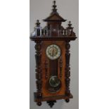 A late 19thC walnut cased Vienna style wall clock, the 15cm dia. dial with Arabic numerals and