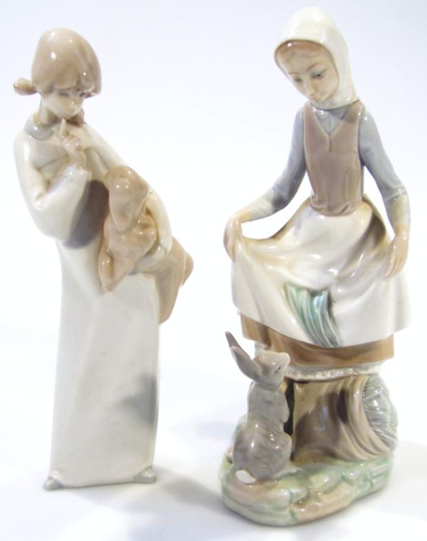 A Lladro Daisa figure group, of a lady holding apron on a naturalistic ground, 25cm high, and a