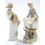 A Lladro Daisa figure group, of a lady holding apron on a naturalistic ground, 25cm high, and a