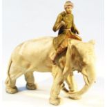 A 19thC bisque porcelain figure of a gentleman riding an elephant, possibly Worcester, he dressed in