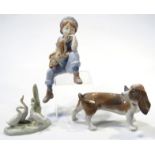 A Lladro figure, of a basset hound, 12cm high, Nao figure of geese and a Nadal figure of a child