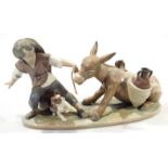 A Lladro Daisa figure group, formed as a child pulling stubborn donkey aside dog on a naturalistic