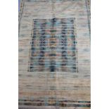 A modern Shiraz Belgium rug, of geometric design on a sand coloured ground, 137cm x 200cm.