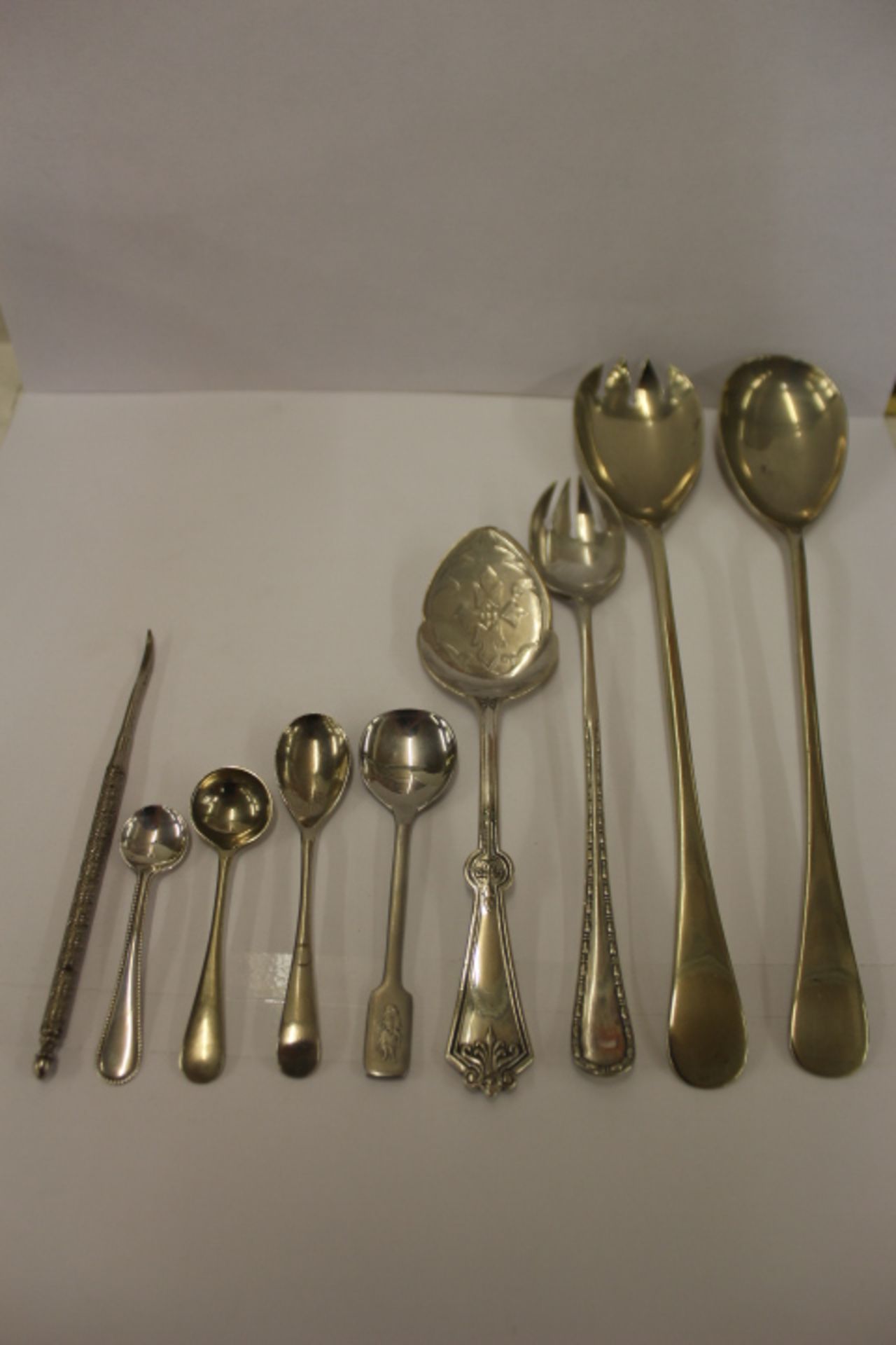 Nine White Metal Spoons