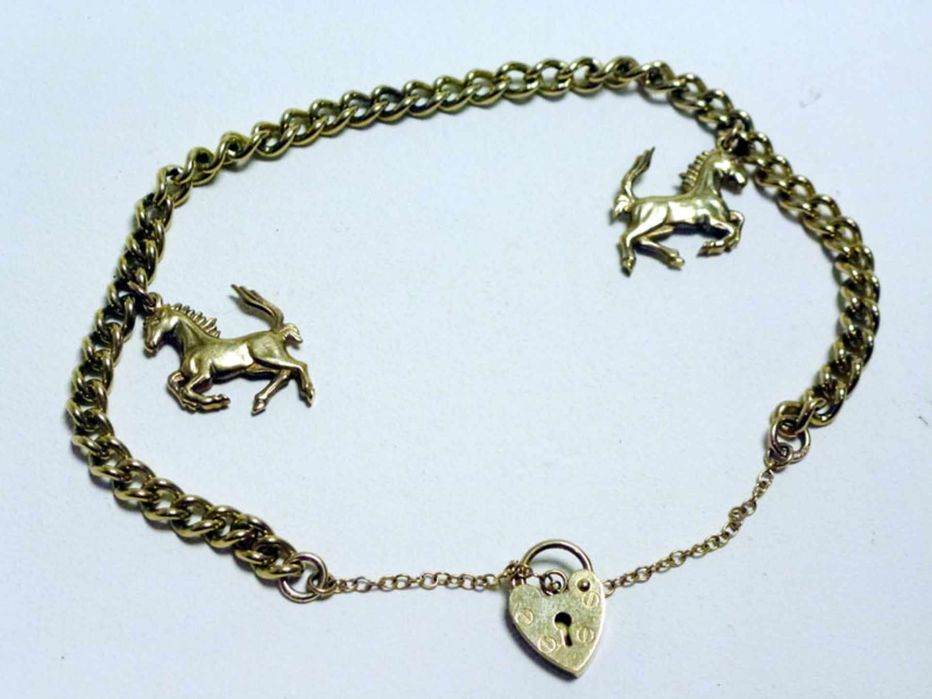A Solid Gold Ferrari 'Prancing Horse' Charm Bracelet
