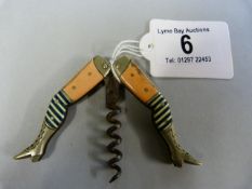 A German novelty corkscrew in the form of a pair of ladies legs, wearing high boots and striped