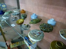 A quantity of various candle holders and 4 pot lids