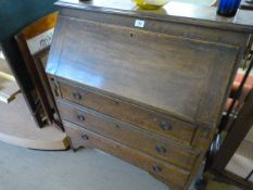 An oak veneered bureau with drawers under
