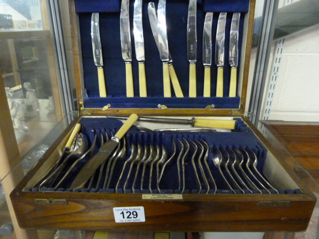 A part canteen of cutlery in an oak case