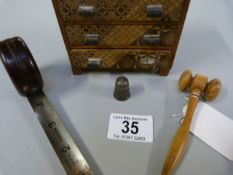 Miniature Tunbridge ware style chest of drawers, gavel, silver thimble and bakelite tape measure