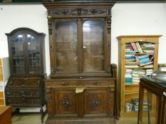 Heavily carved Flemish Oak bookcase with cupboard under