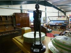 Modern bronze of a scantily clad lady with a whip