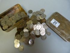 A quantity of coins in a tin