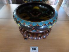 A Cloisonne bowl decorated with a dragon on a stand